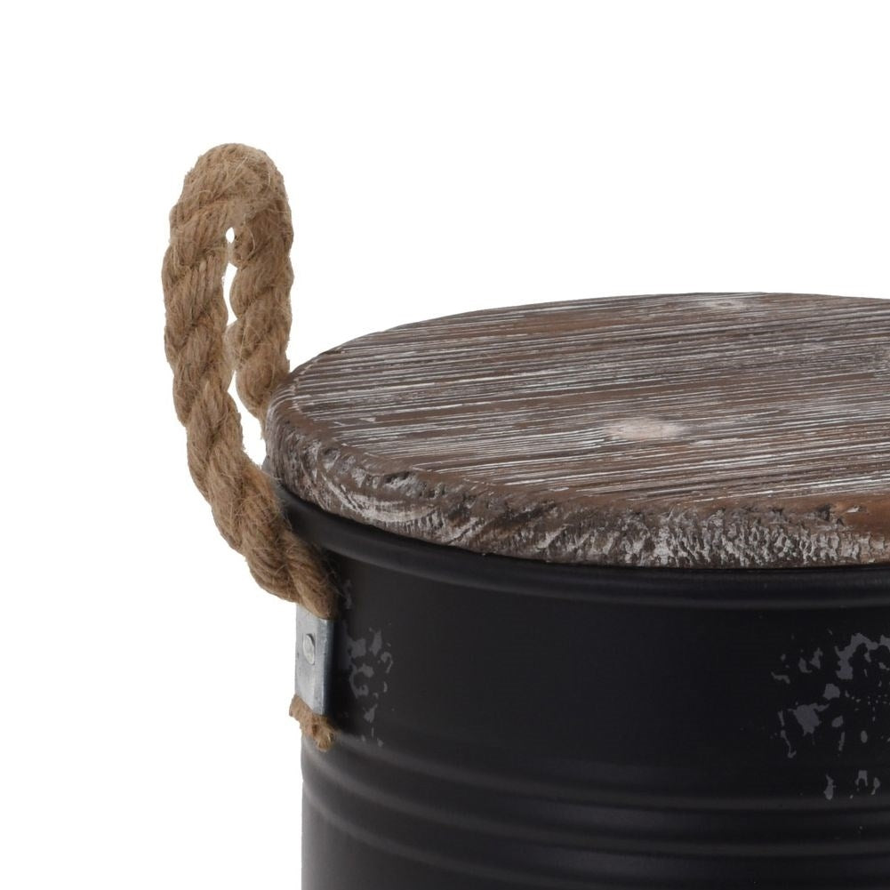 Black metal barrel with wooden lid and rope handle for decoration