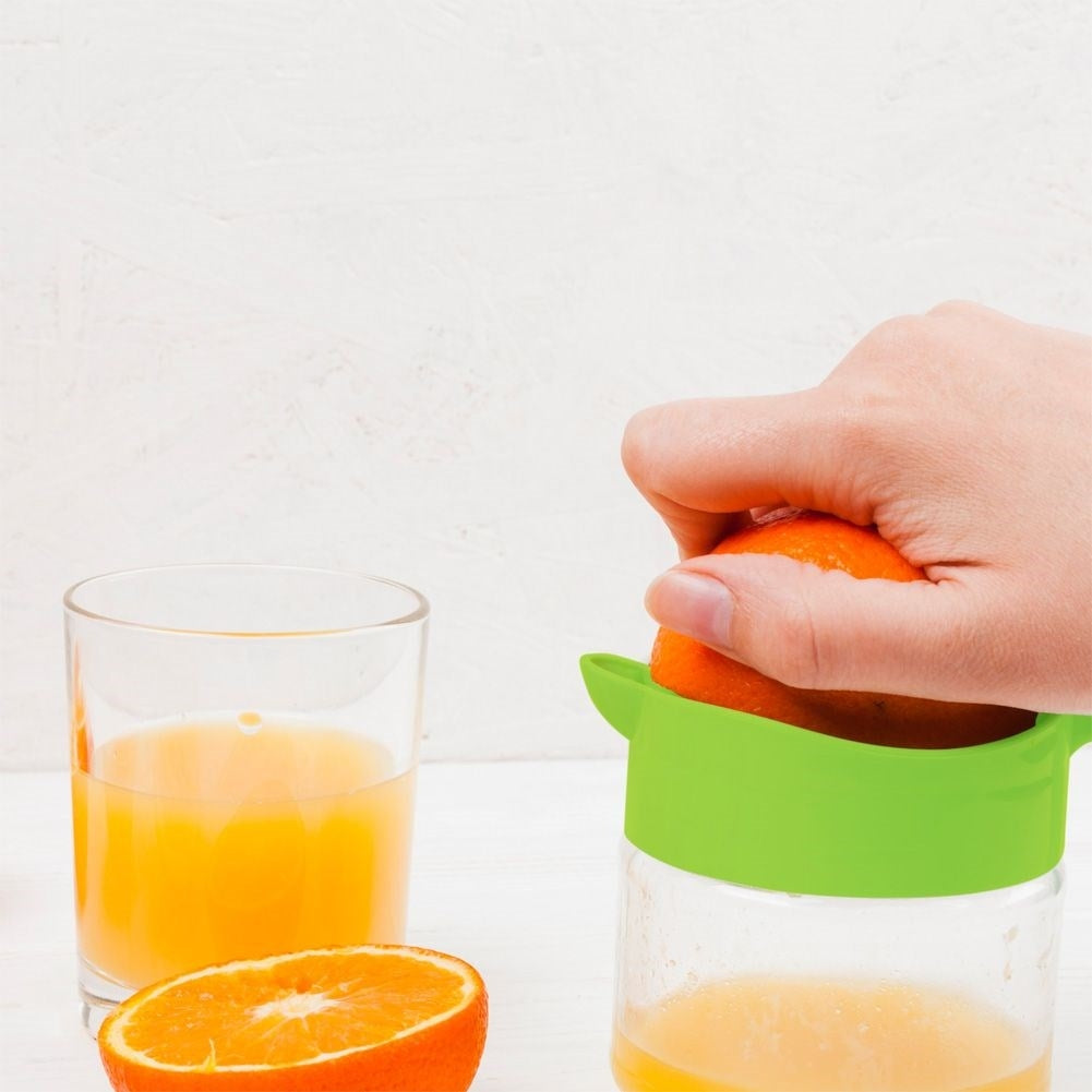 Citrus press with spout and glass container for fresh juice