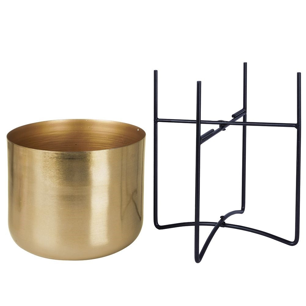 Elegant gold flower pot on black metal stand for modern interior design