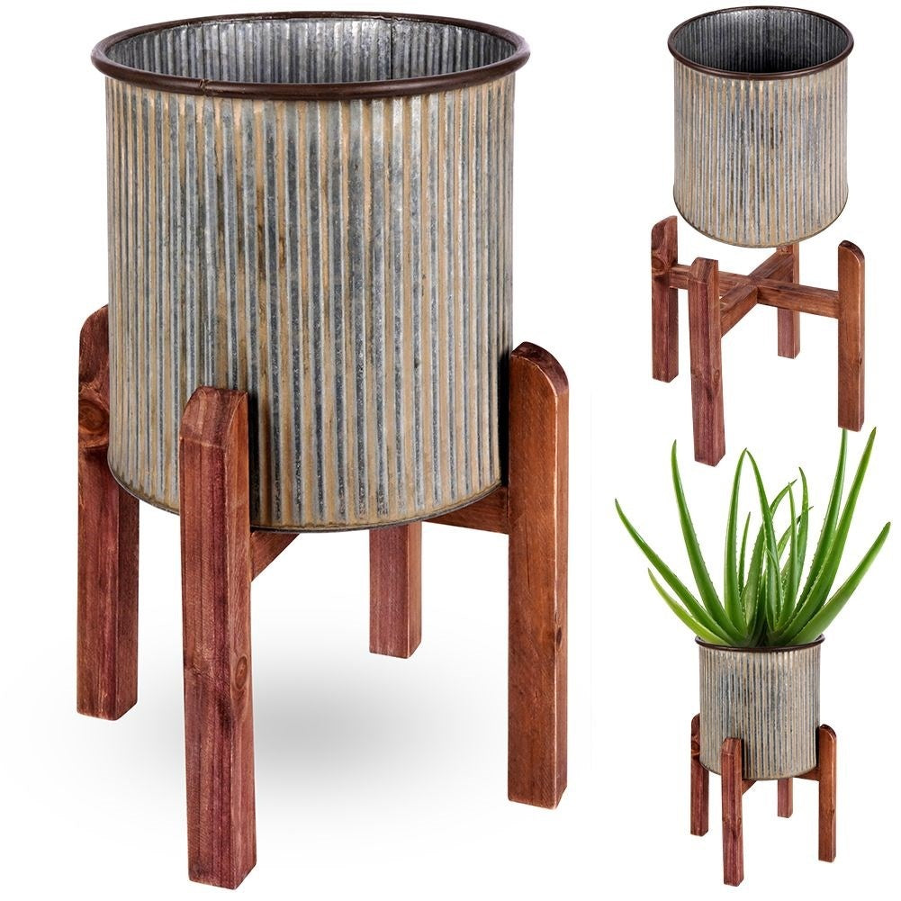 Silver colored fluted flower pot on a wooden stand