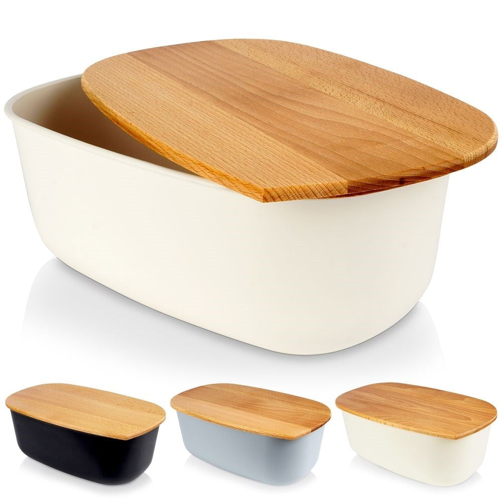 Spacious cream colored bread box with wooden cutting board