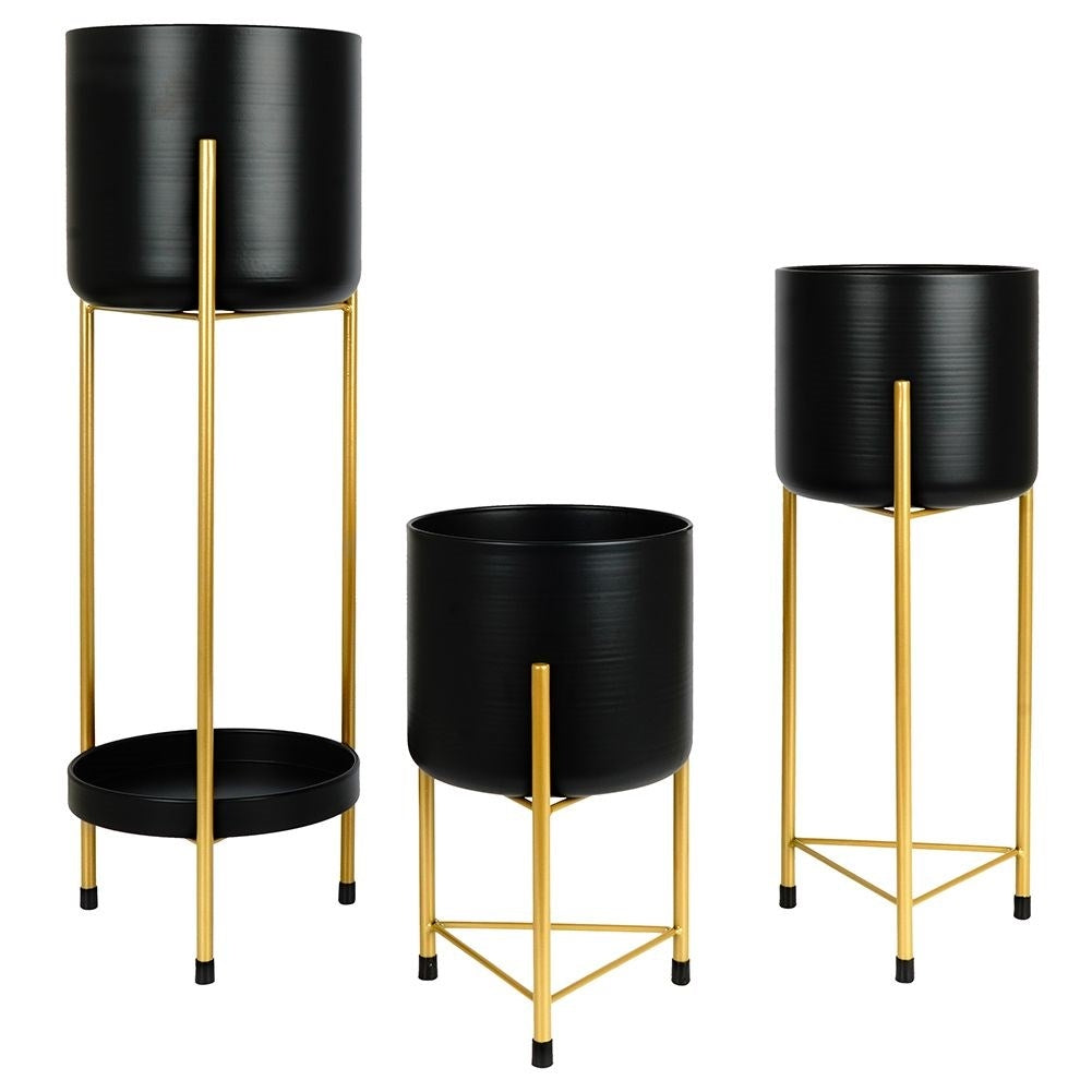 Three black flower pots on gold stand for elegant plant display