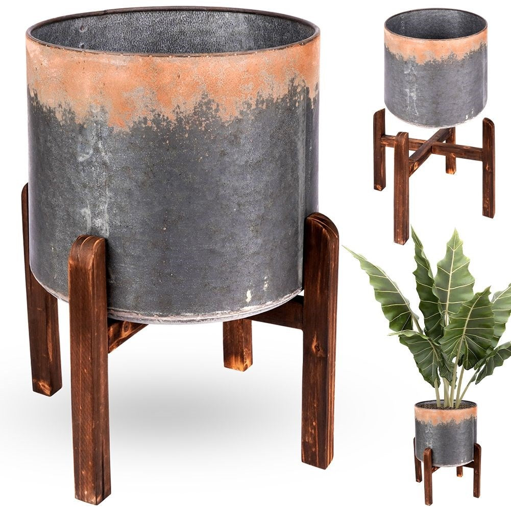 Vintage flower pot in steel with a rusty effect on a wooden stand