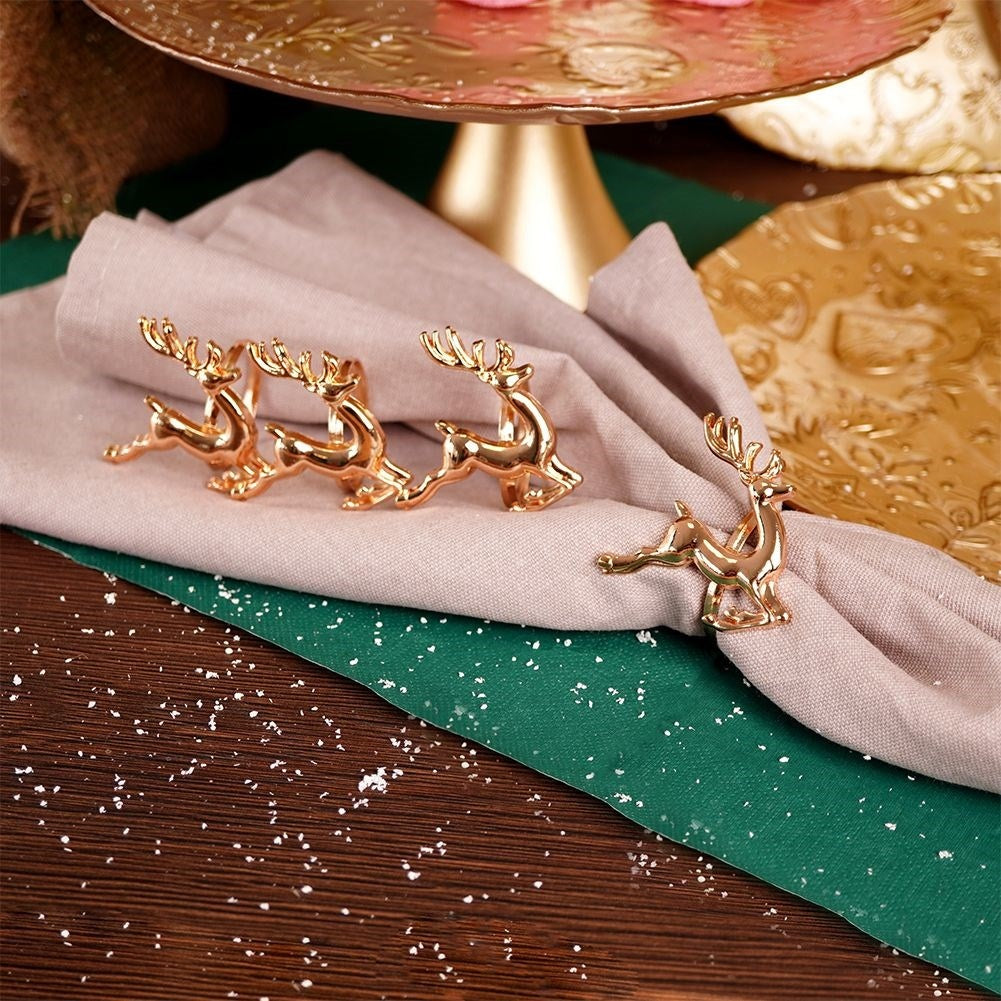 4 napkin rings in gold with reindeer, 4 cm diameter