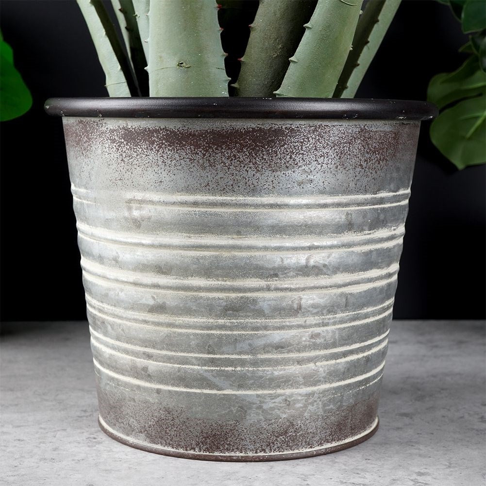 Antique galvanized metal pot with rusty finish