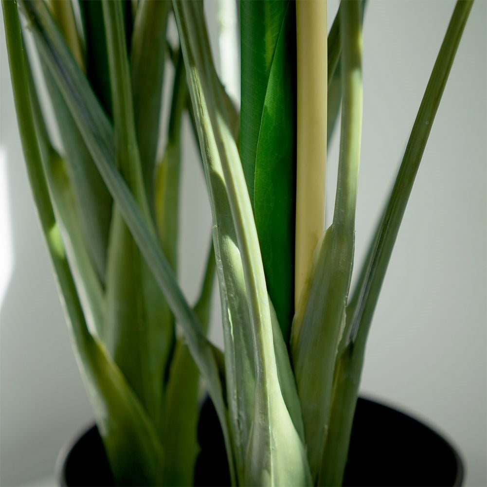 Artificial cold plant with three flowers in black pot