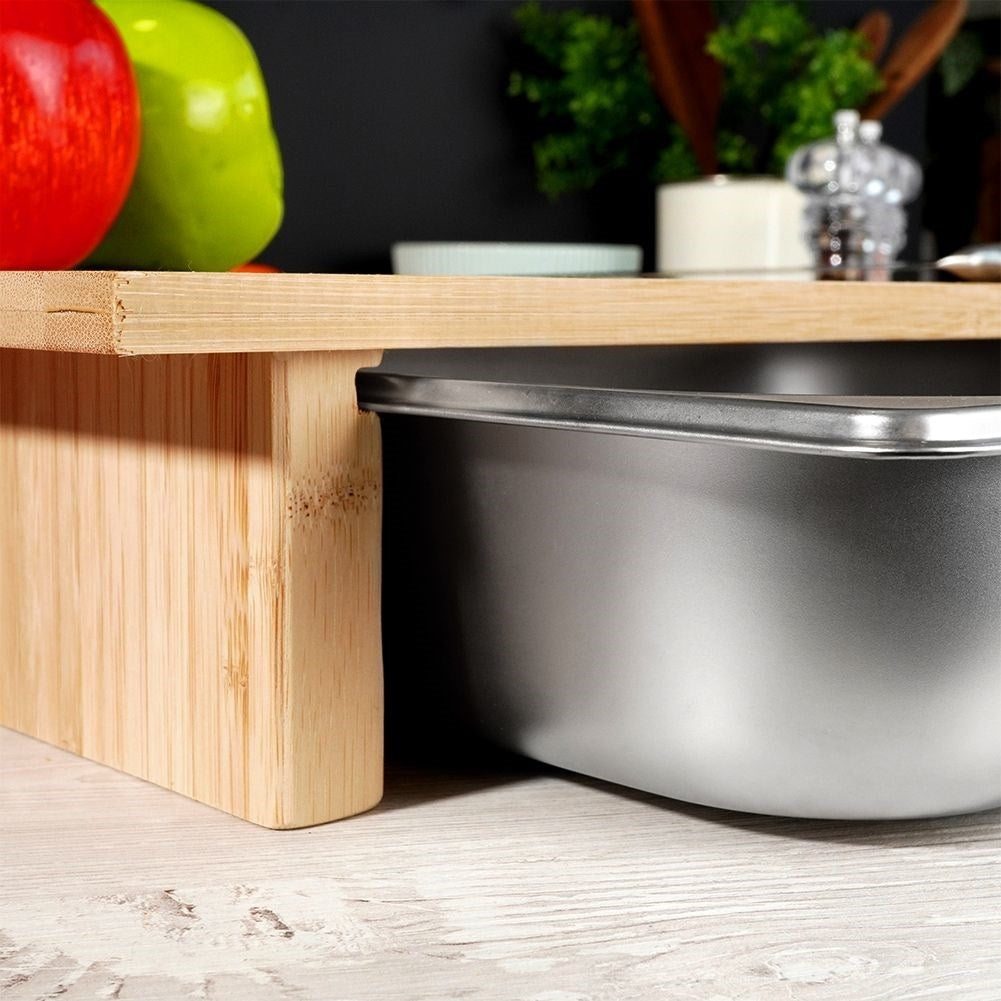 Bamboo cutting board with extendable steel container