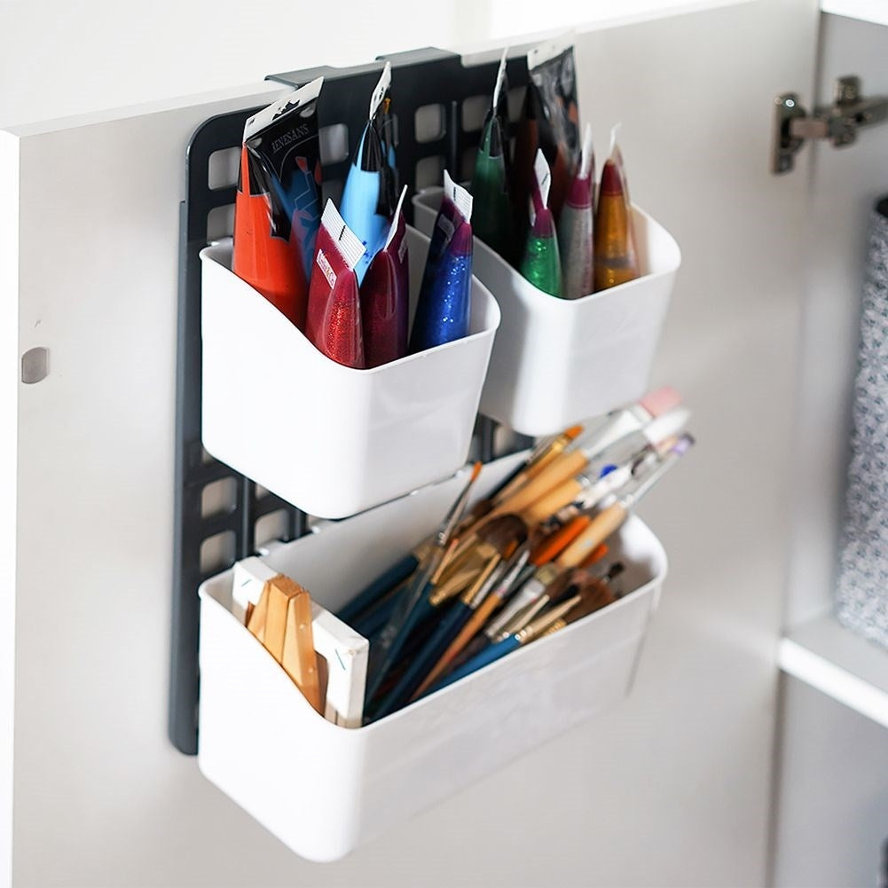 Basket for cabinet doors or shower cubicles with three compartments