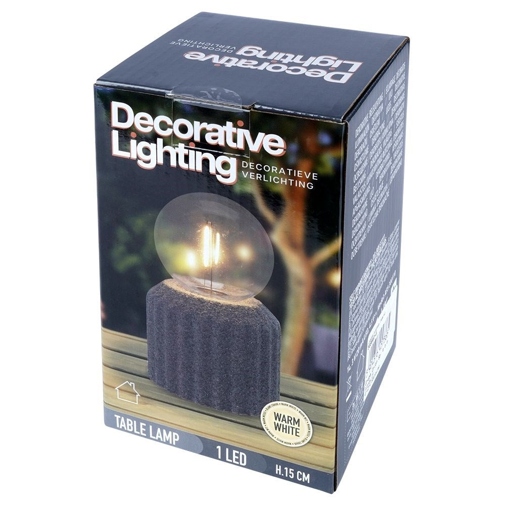 Battery-powered LED table lamp with a cement-like base