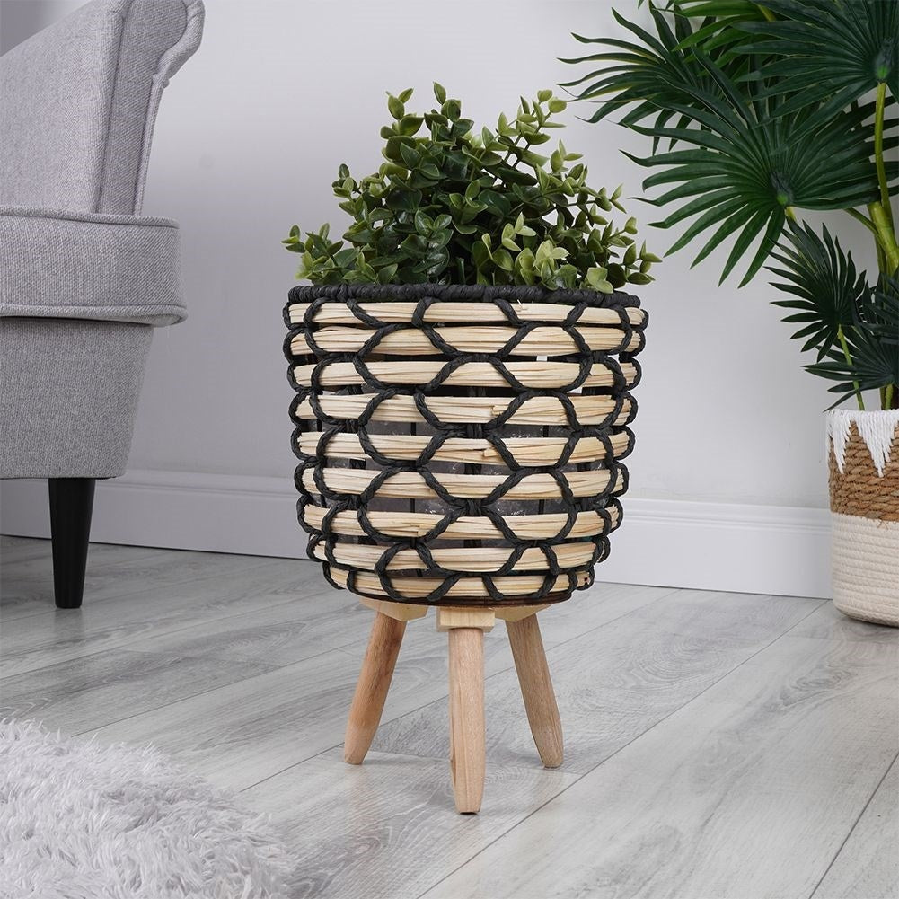 Beautiful flower pot in braided wooden design with sturdy wooden legs