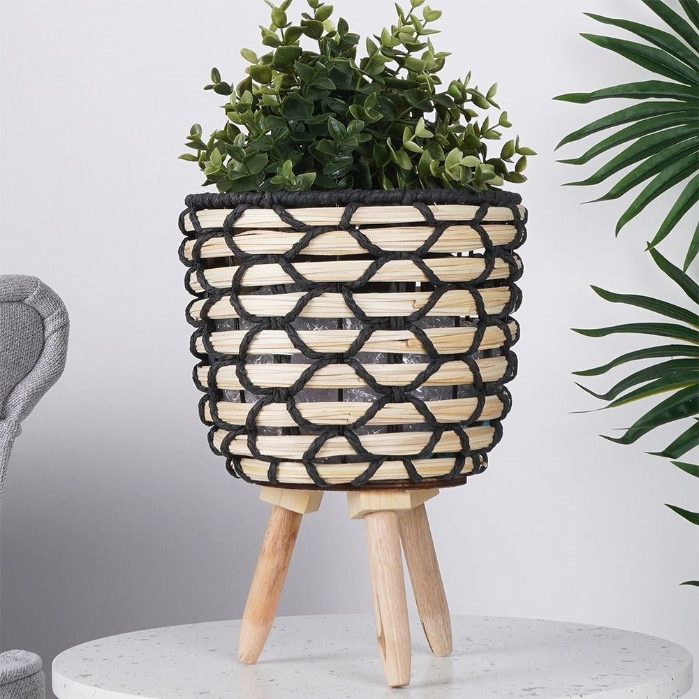 Beautiful flower pot in braided wooden design with sturdy wooden legs