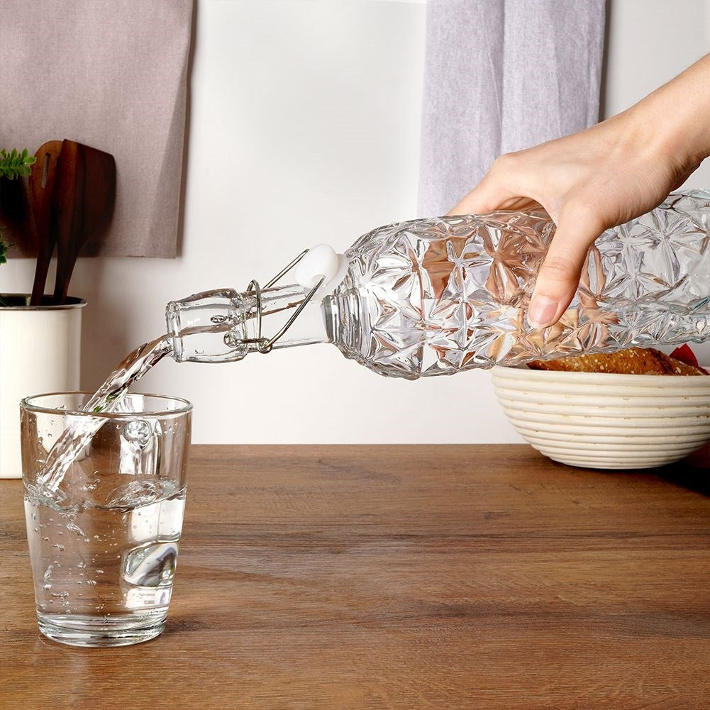 Beautiful glass bottle with cork and clamp for drinks