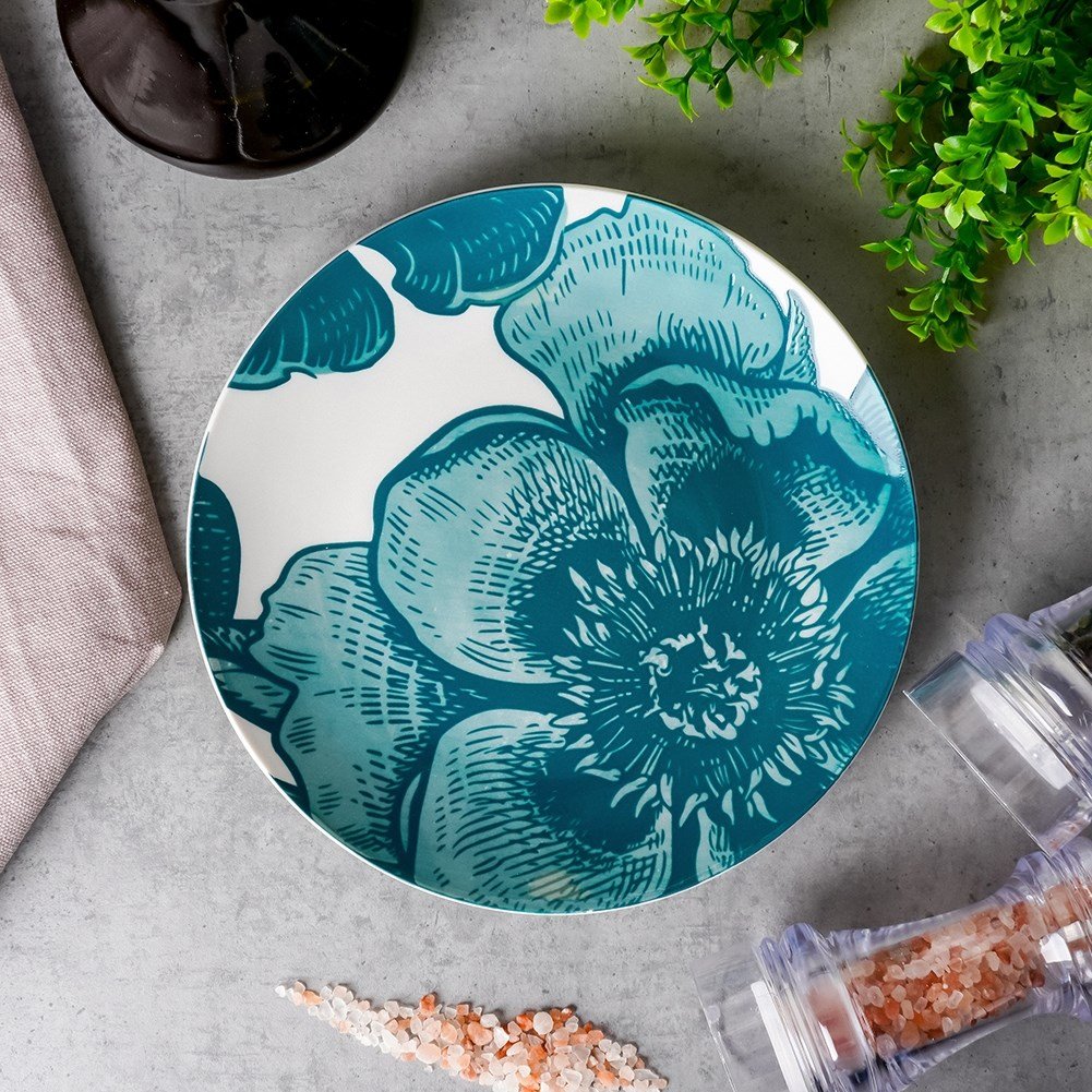 Beautiful white porcelain dish with turquoise floral motifs for desserts