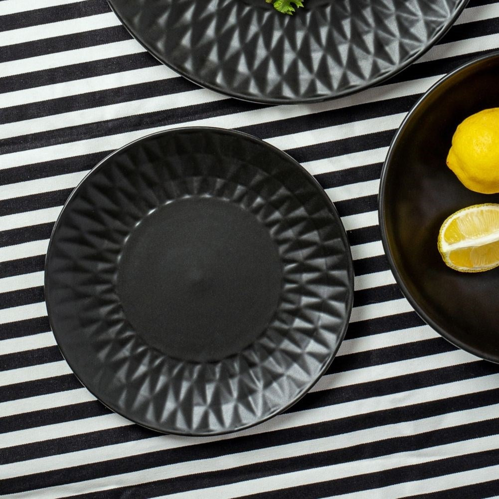 Black ceramic dessert plate with decorative pattern