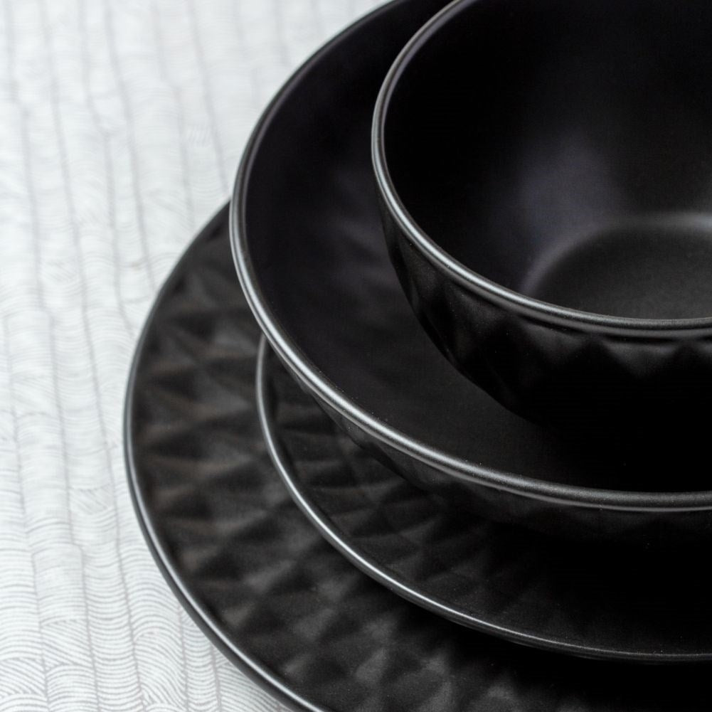 Black ceramic dessert plate with decorative pattern
