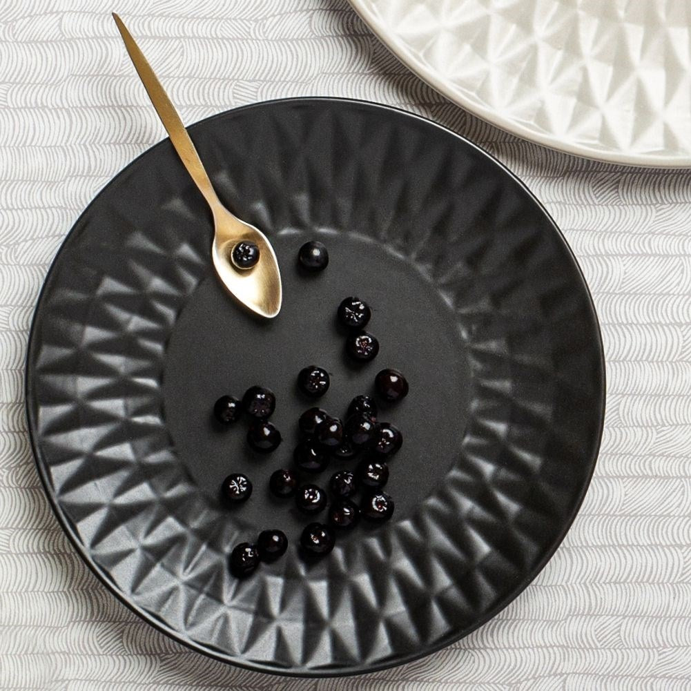 Black ceramic dessert plate with decorative pattern