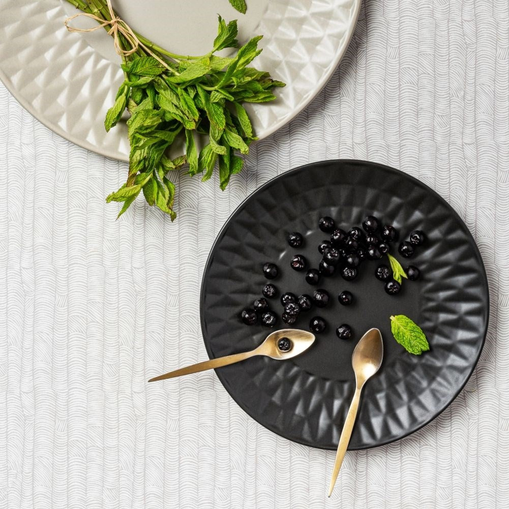 Black ceramic dessert plate with decorative pattern