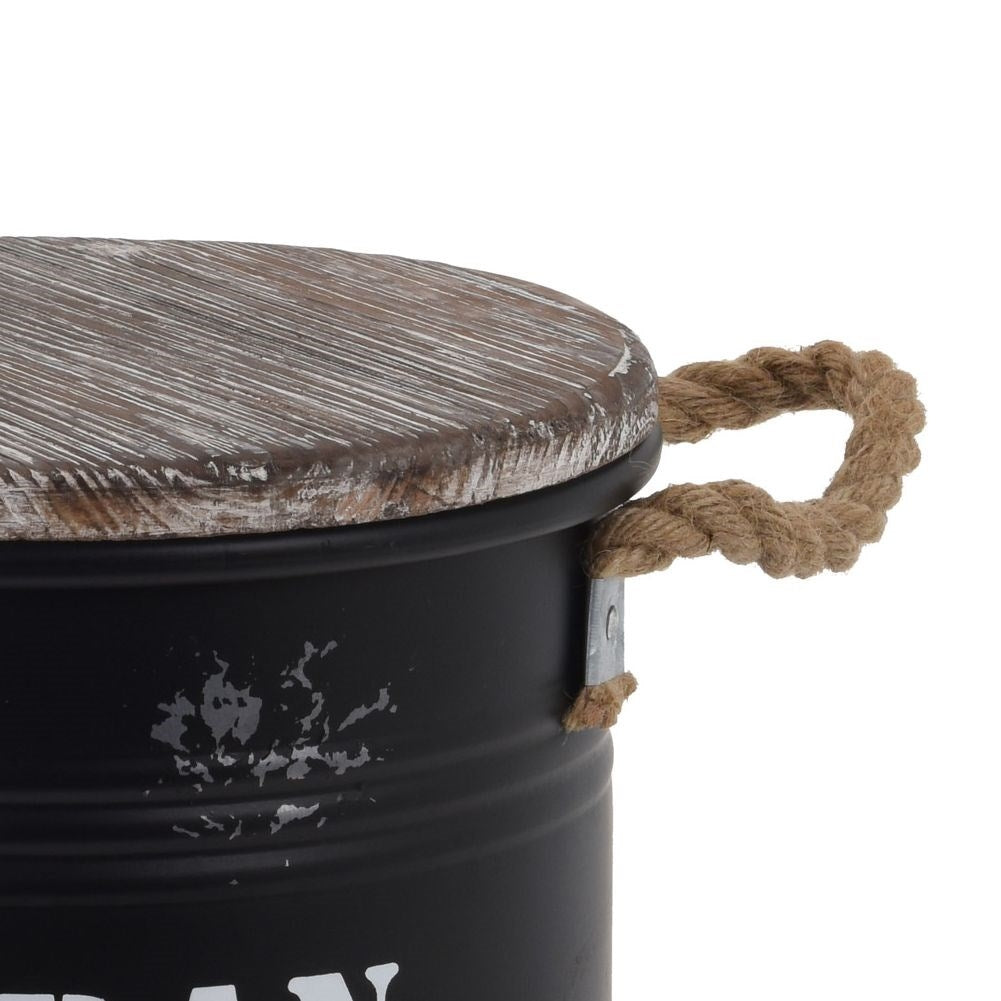Black metal barrel with wooden lid and rope handle