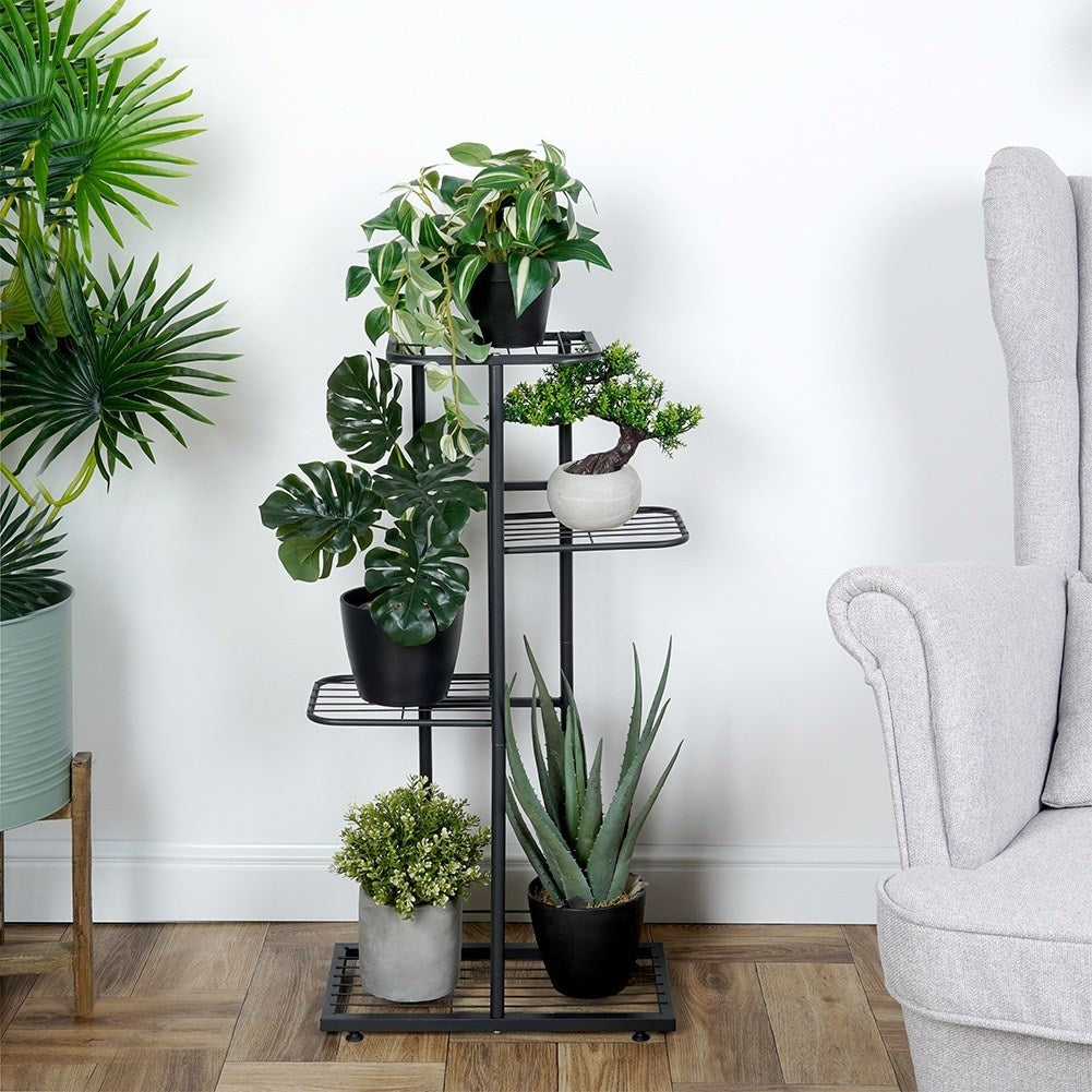 Black metal flower stand with four levels for indoor use