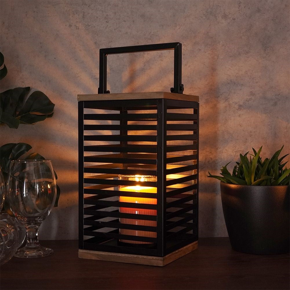 Black metal lantern with large glass insert for outside and inside