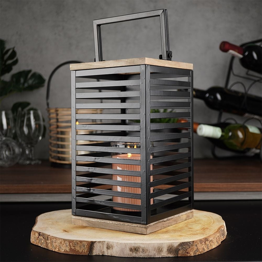 Black metal lantern with large glass insert for outside and inside