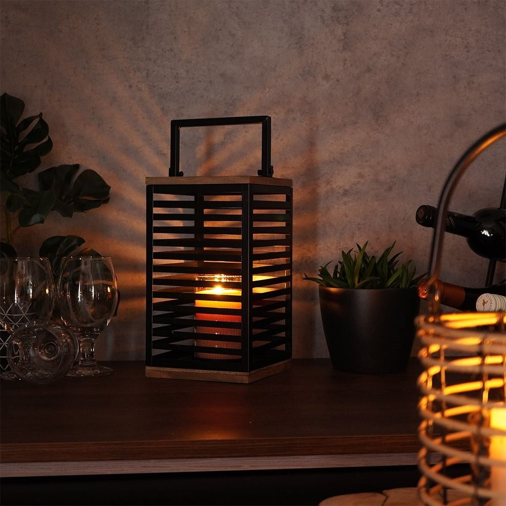 Black metal lantern with large glass insert for outside and inside