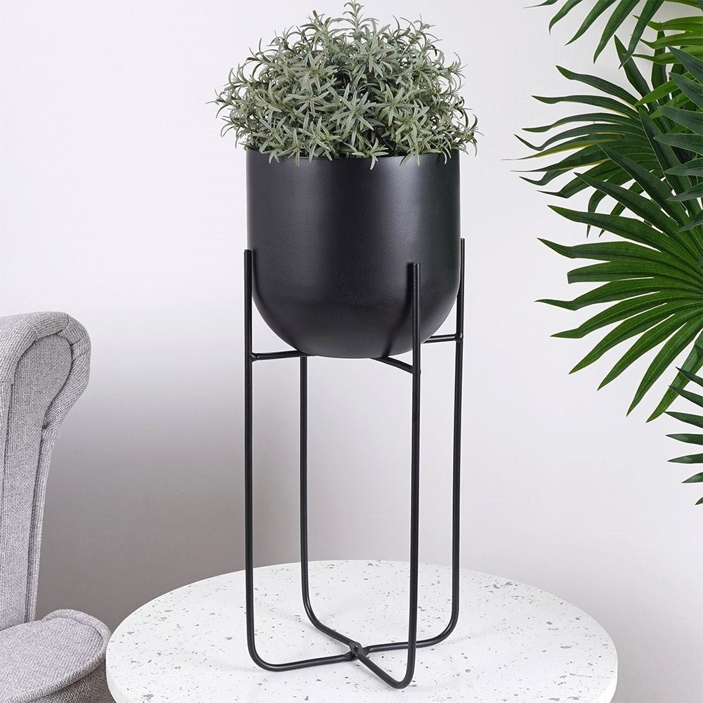 Black metal pot on stand for modern decor