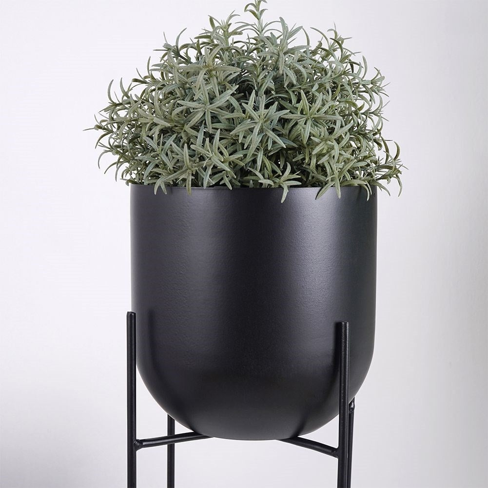 Black metal pot on stand for modern decor