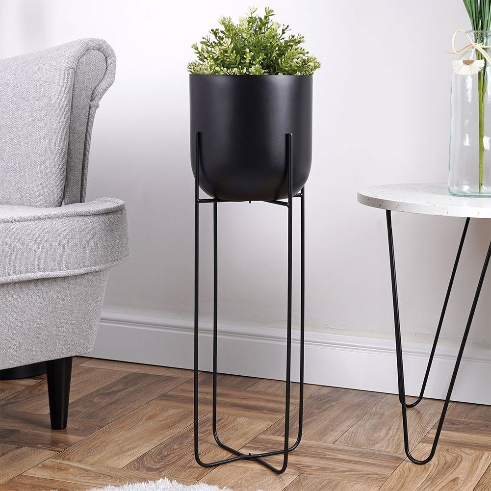 Black metal pot on stand for modern interiors