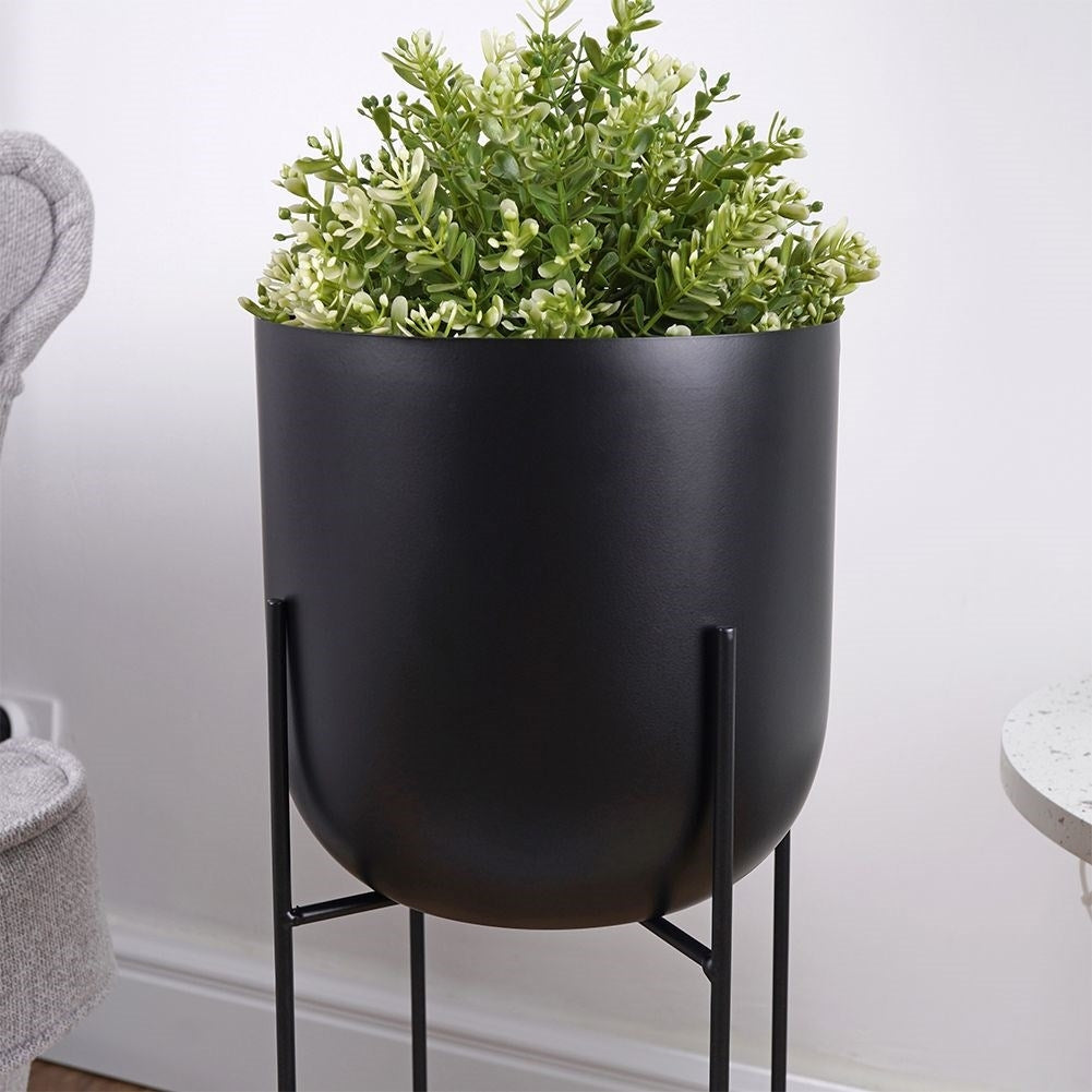 Black metal pot on stand for modern interiors