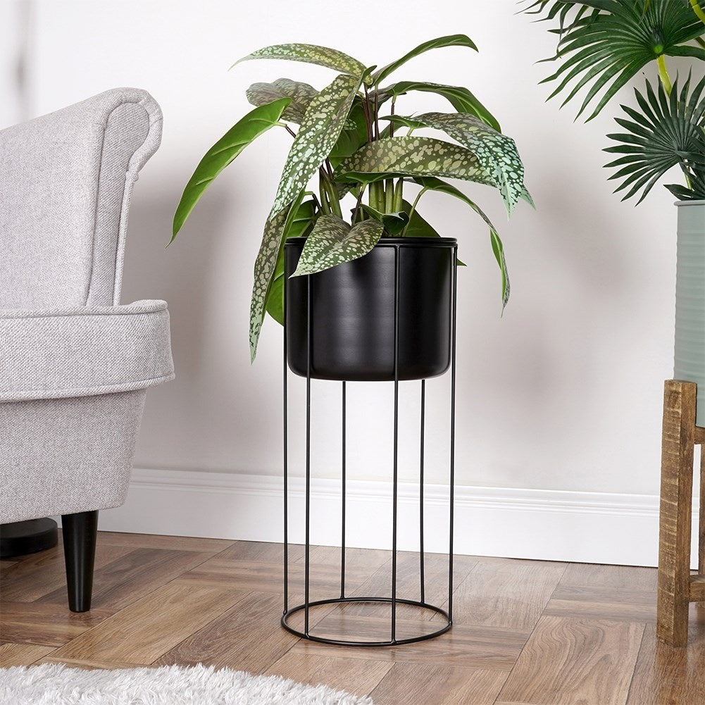 Black metal pot on stand for stylish plant display