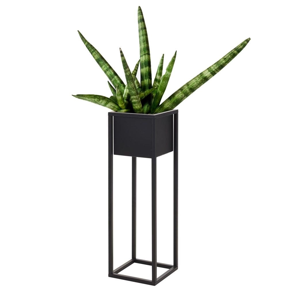 Black metal pot on stand in industrial style