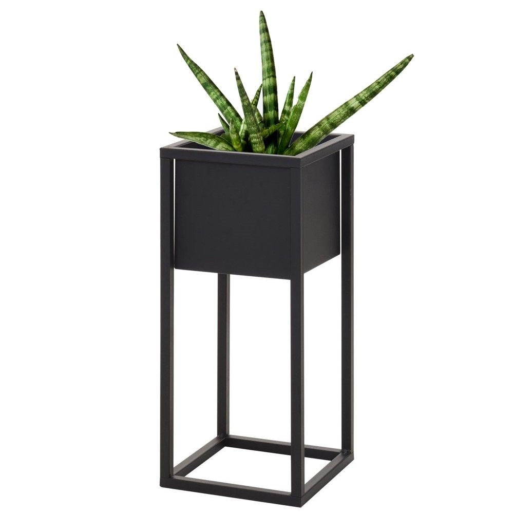 Black metal pot on stand in industrial style