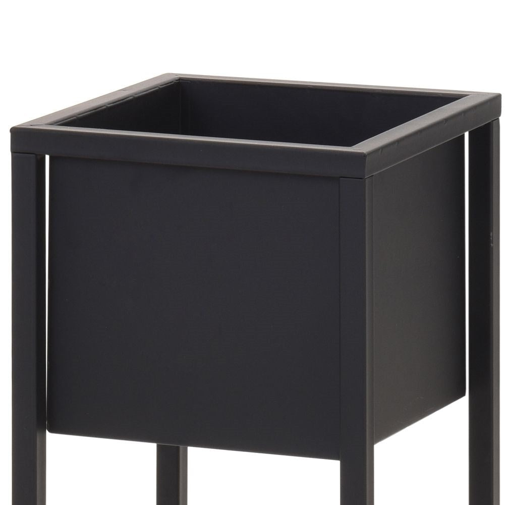 Black metal pot on stand in industrial style