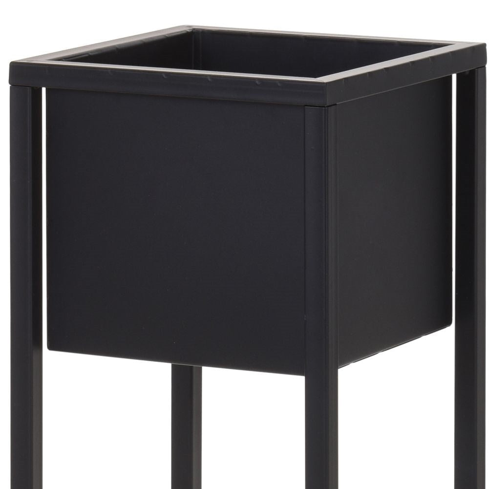 Black metal pot on stand in industrial style