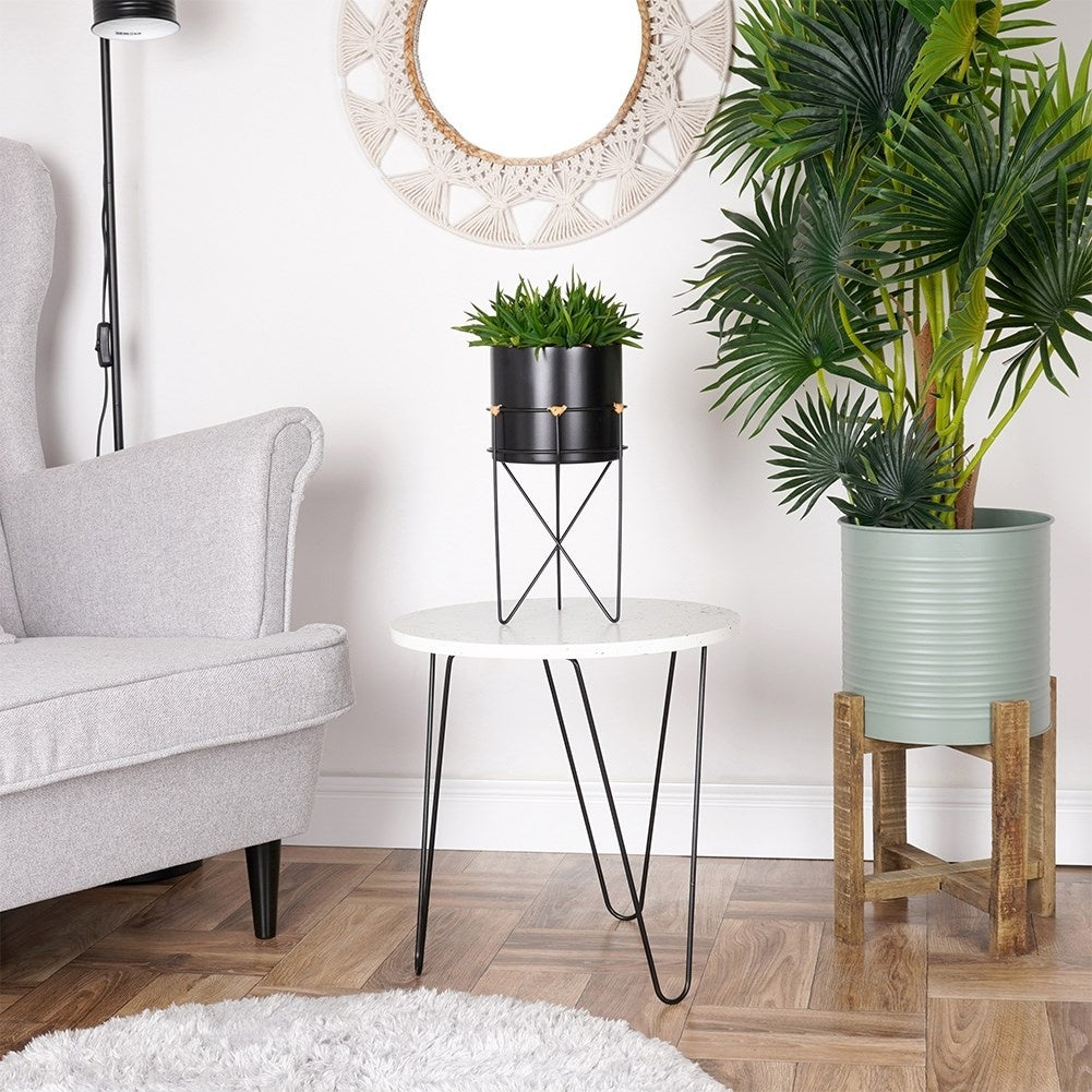 Black metal pot with stand for stylish plant display