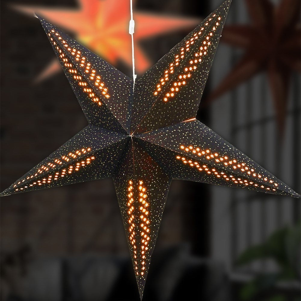 Black paper star with lighting and silver glitter