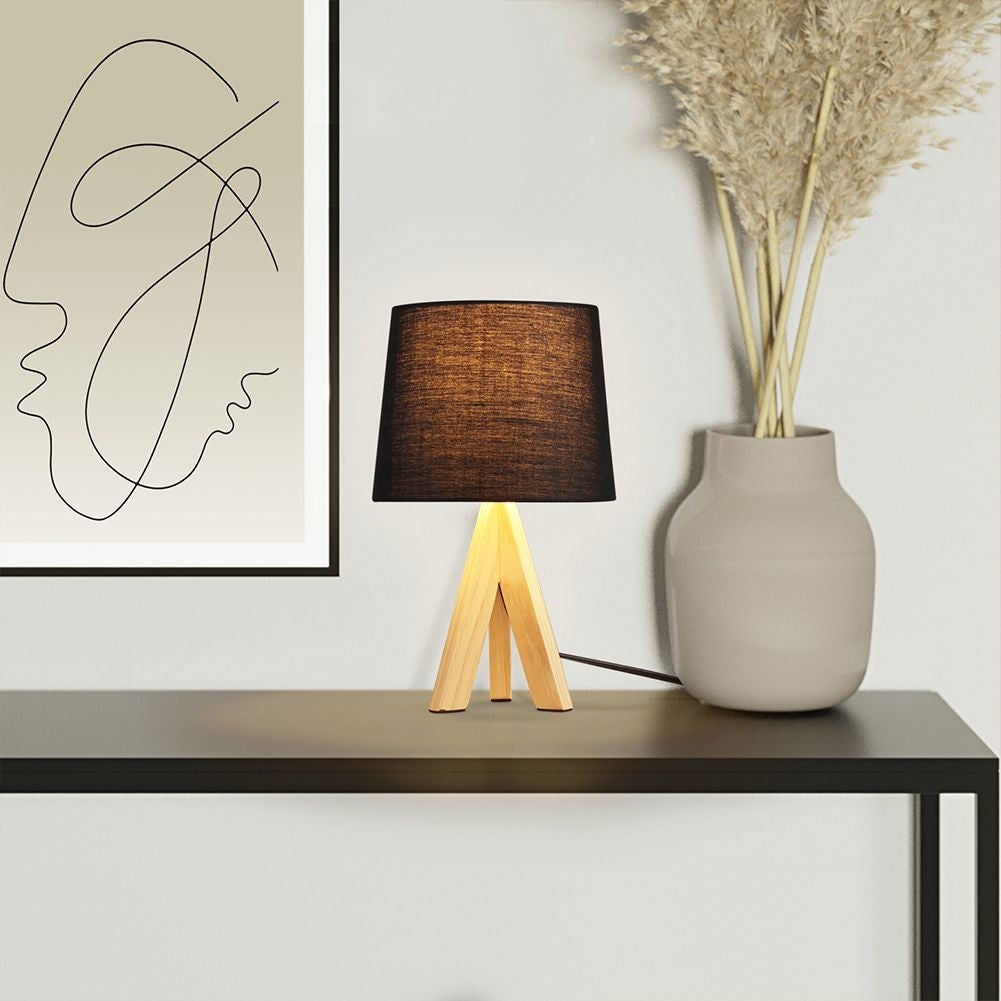 Black table lamp with shade and wooden legs for home and office