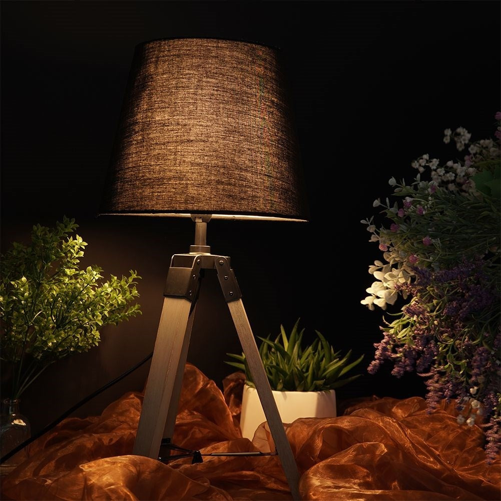 Black table lamp with shade and wooden legs for home and office