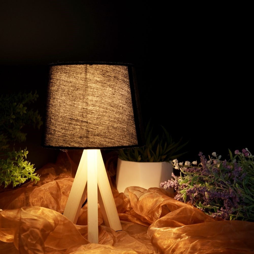 Black table lamp with shade and wooden legs for home and office