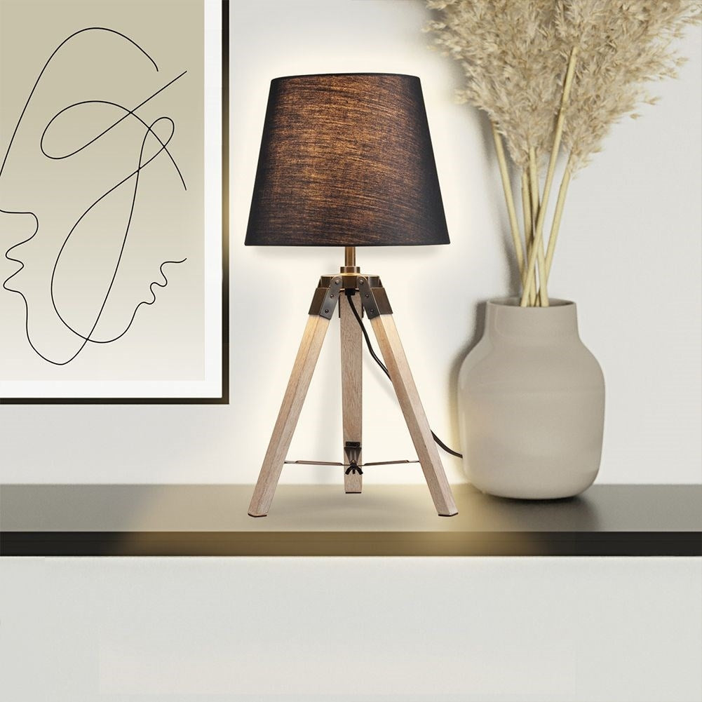Black table lamp with shade and wooden legs for home and office