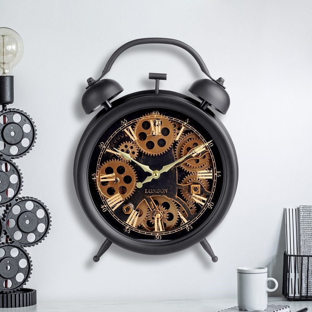 Black wall clock with moving gold gears and Roman numerals