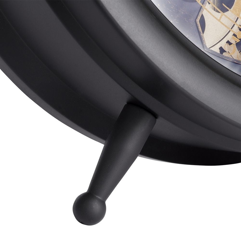 Black wall clock with moving gold gears and Roman numerals