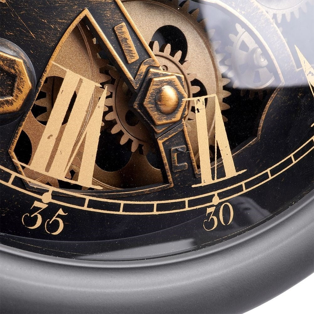 Black wall clock with moving gold gears and Roman numerals