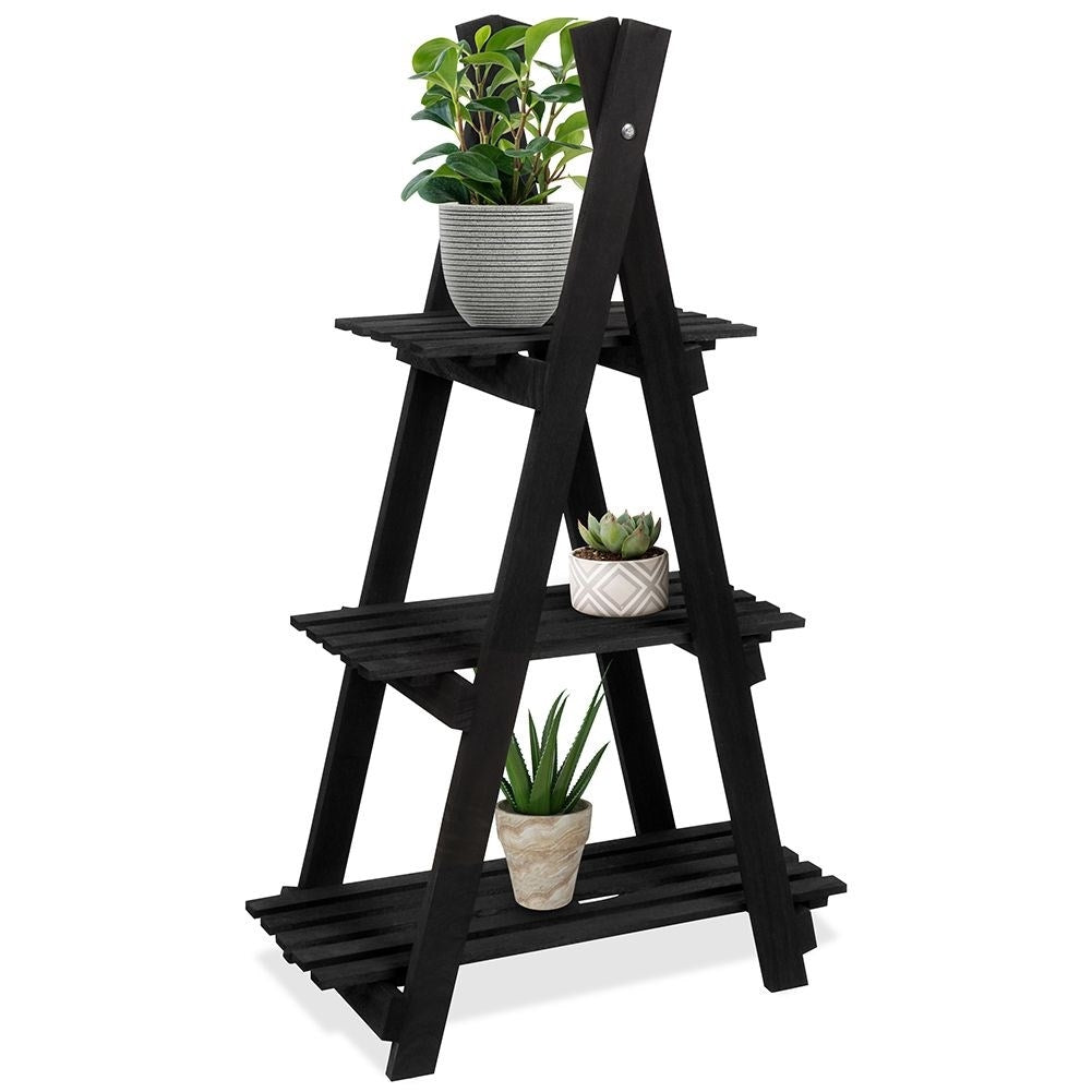 Black wooden flower stand with three levels in an industrial style