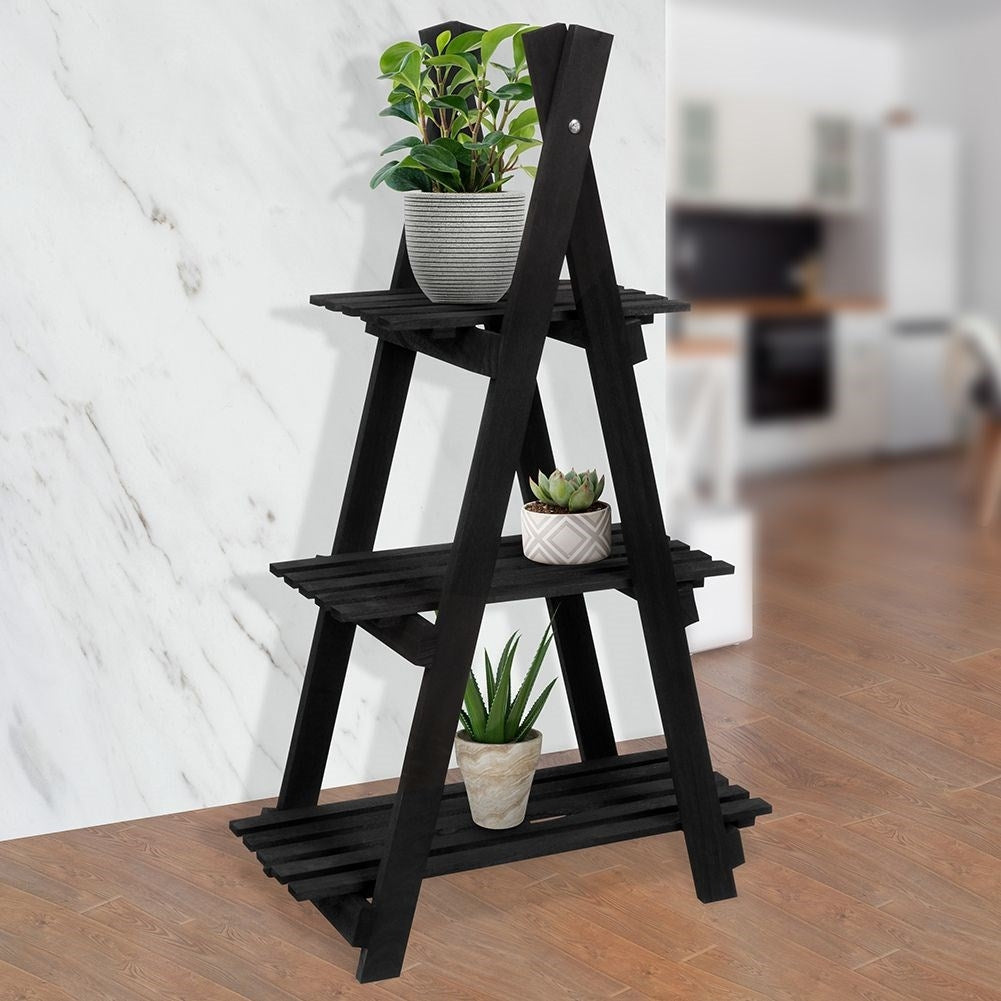 Black wooden flower stand with three levels in an industrial style