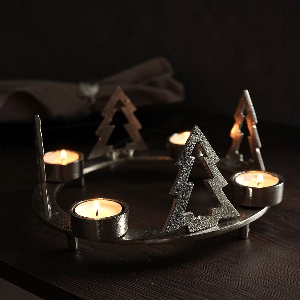 Candle holder for four candles with fir trees in silver aluminium