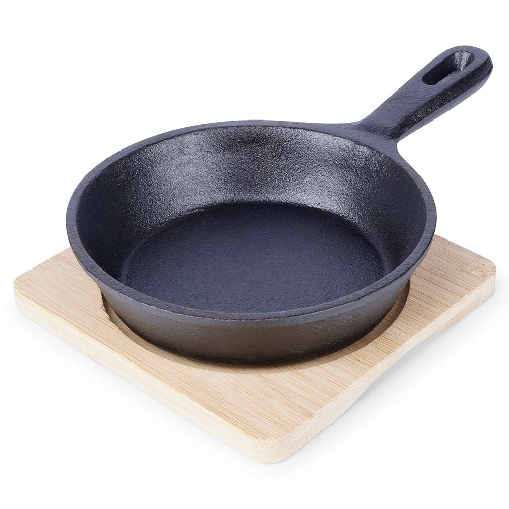 Cast iron dish with wooden tray for tapas and snacks