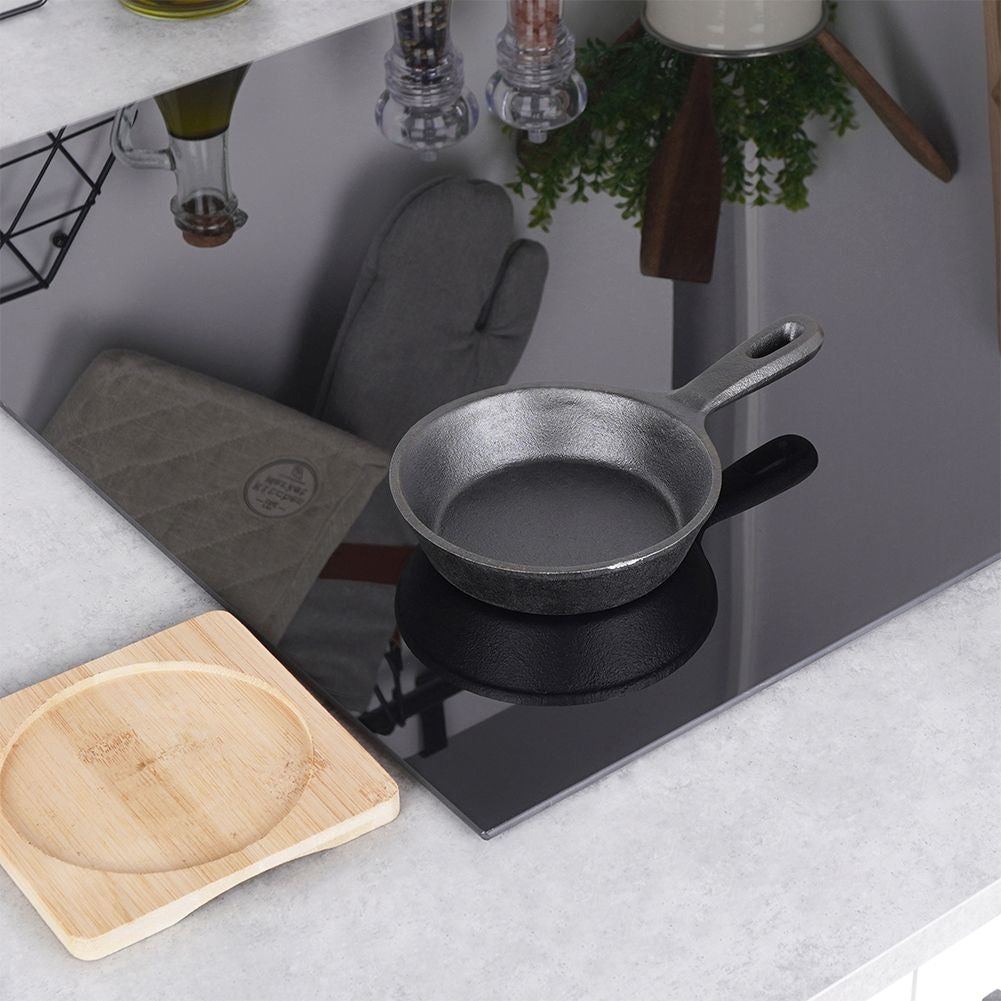 Cast iron dish with wooden tray for tapas and snacks