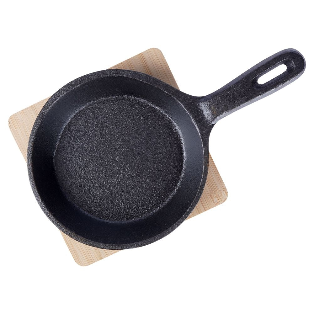 Cast iron dish with wooden tray for tapas and snacks